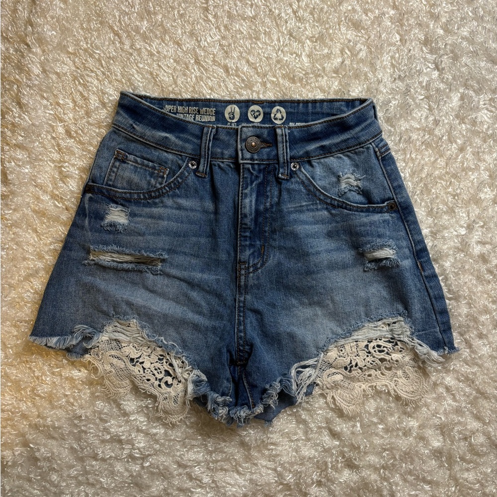 High-Waisted Denim Shorts with Lace Trim at the bottom.